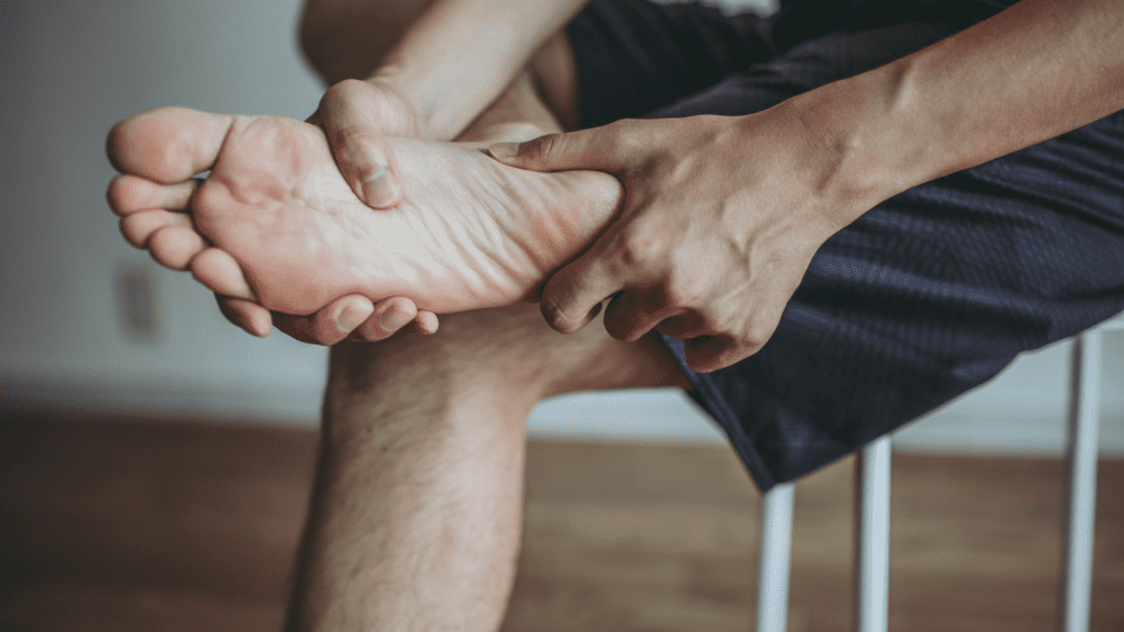 Man holding foot in pain
