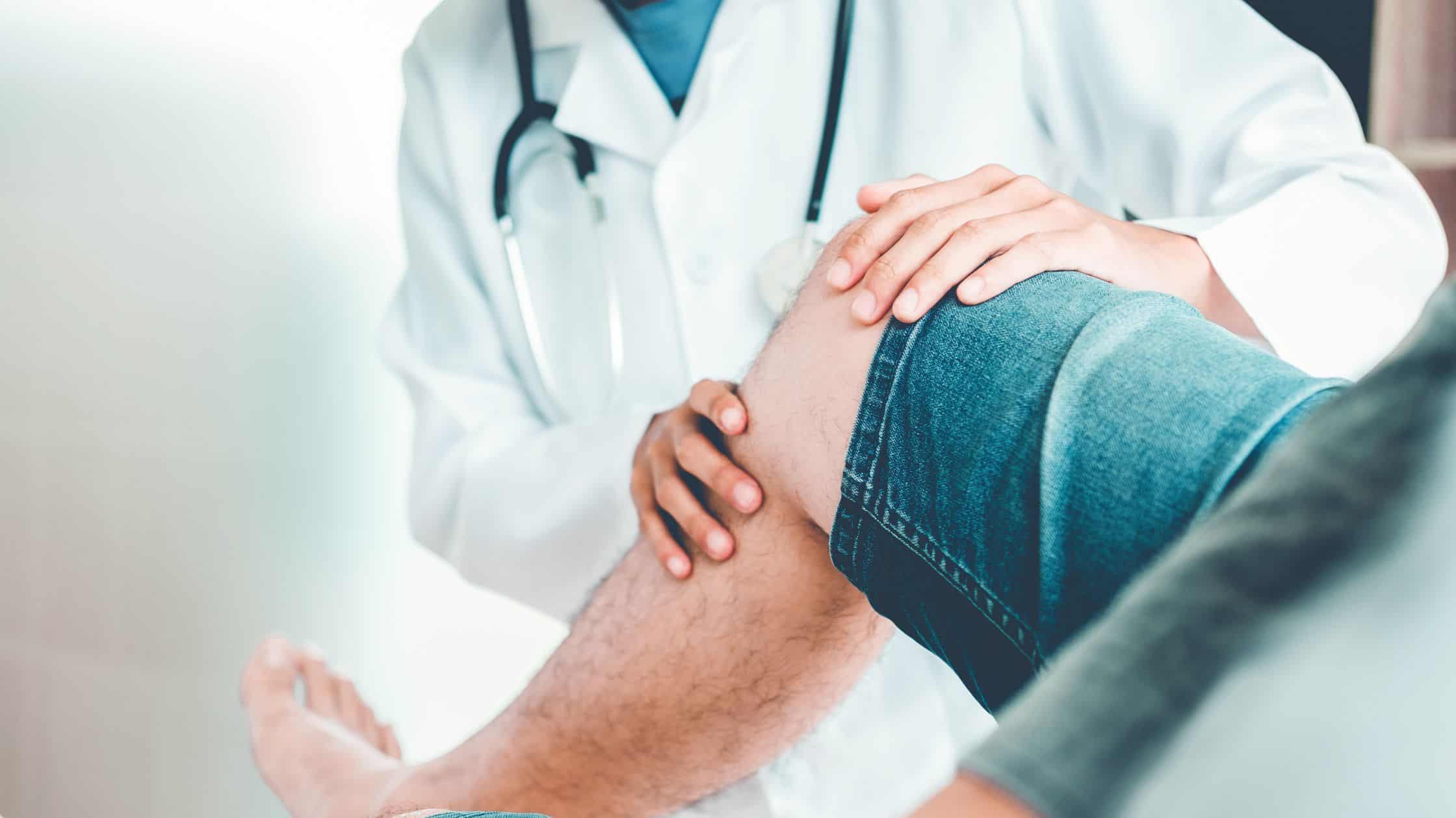 doctor with patient looking at knee