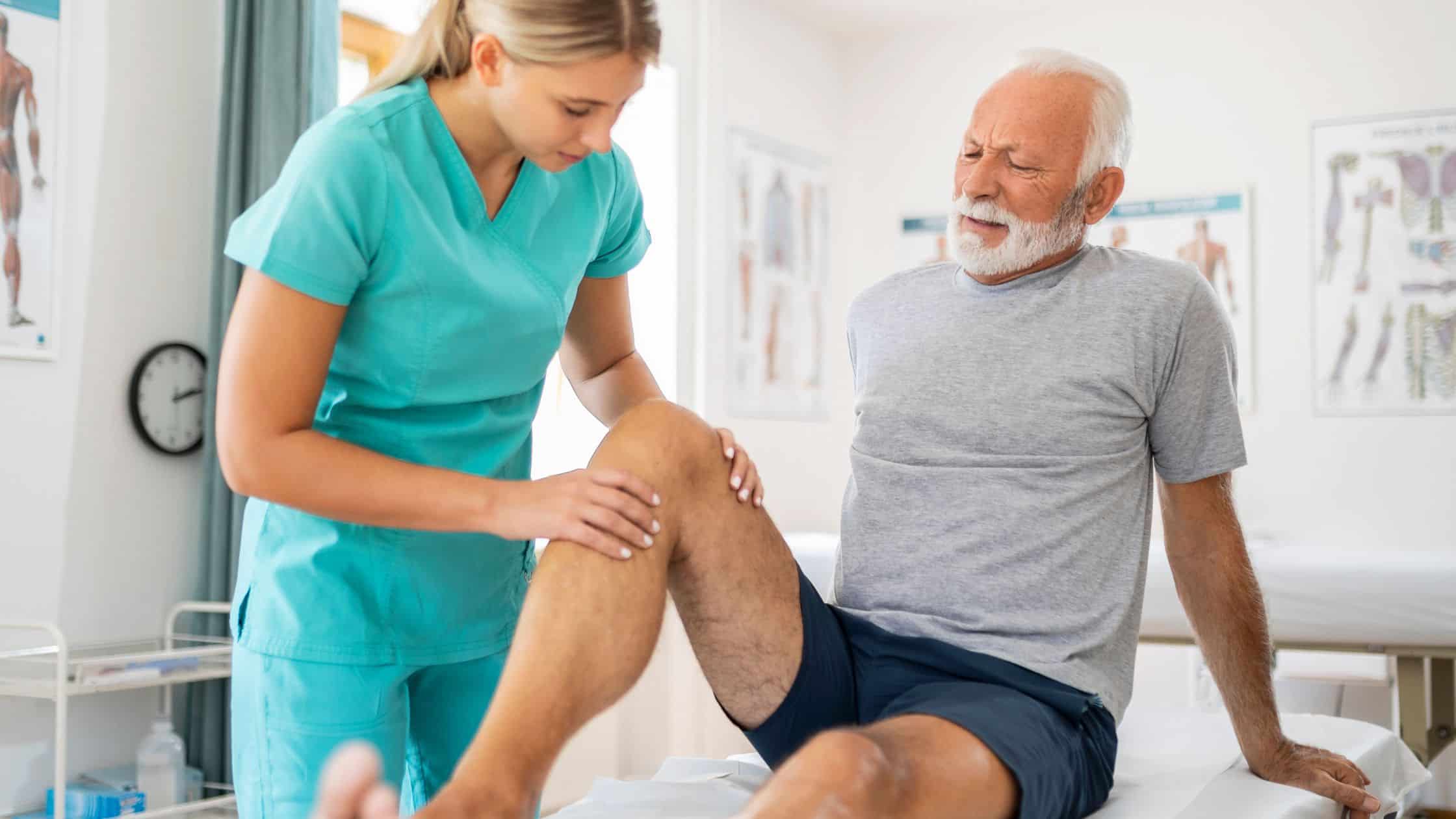 a doctor with patient over knee pain 